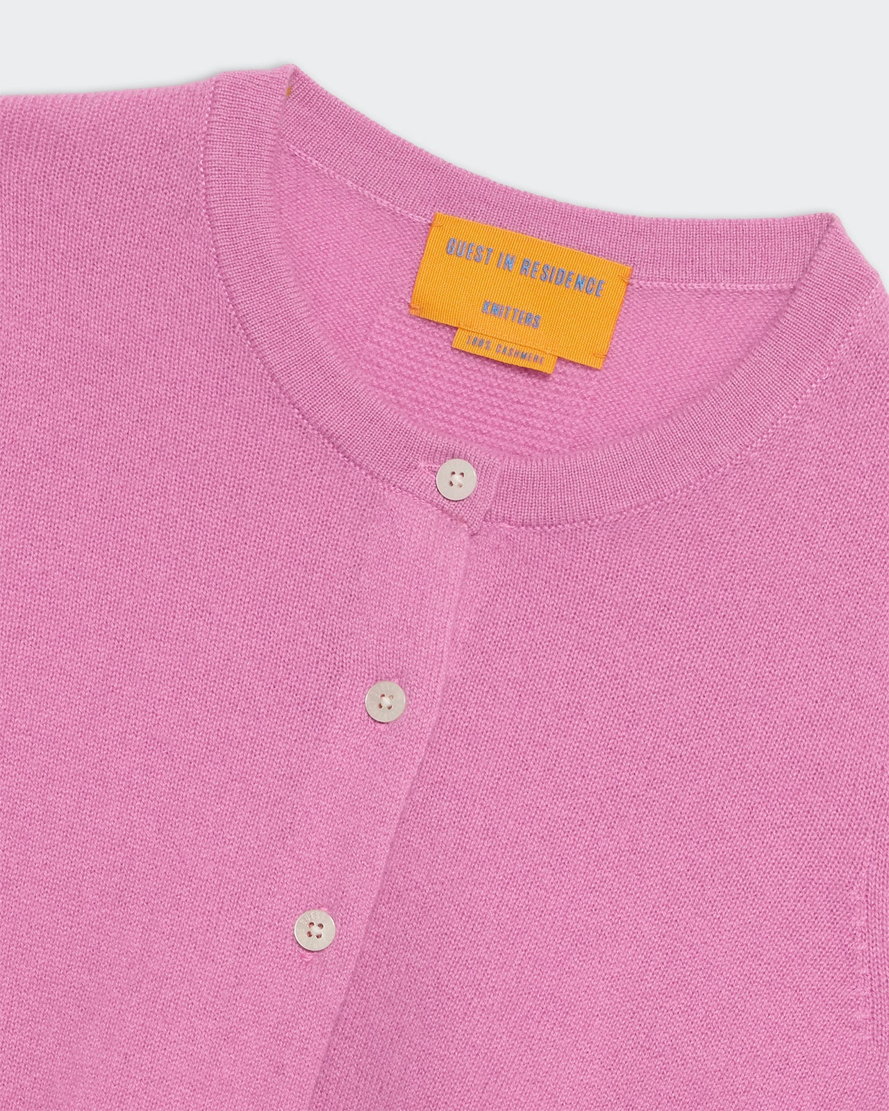 Close-up of rose pink lightweight cashmere Jane cardigan with rib hem, button front, and round neck trim