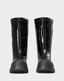 Front view of Rudsak KRISTAL HI - 8222510 BLACK boots in high-gloss black, featuring chunky grip soles and prominent front zippers, set against a plain light gray background.