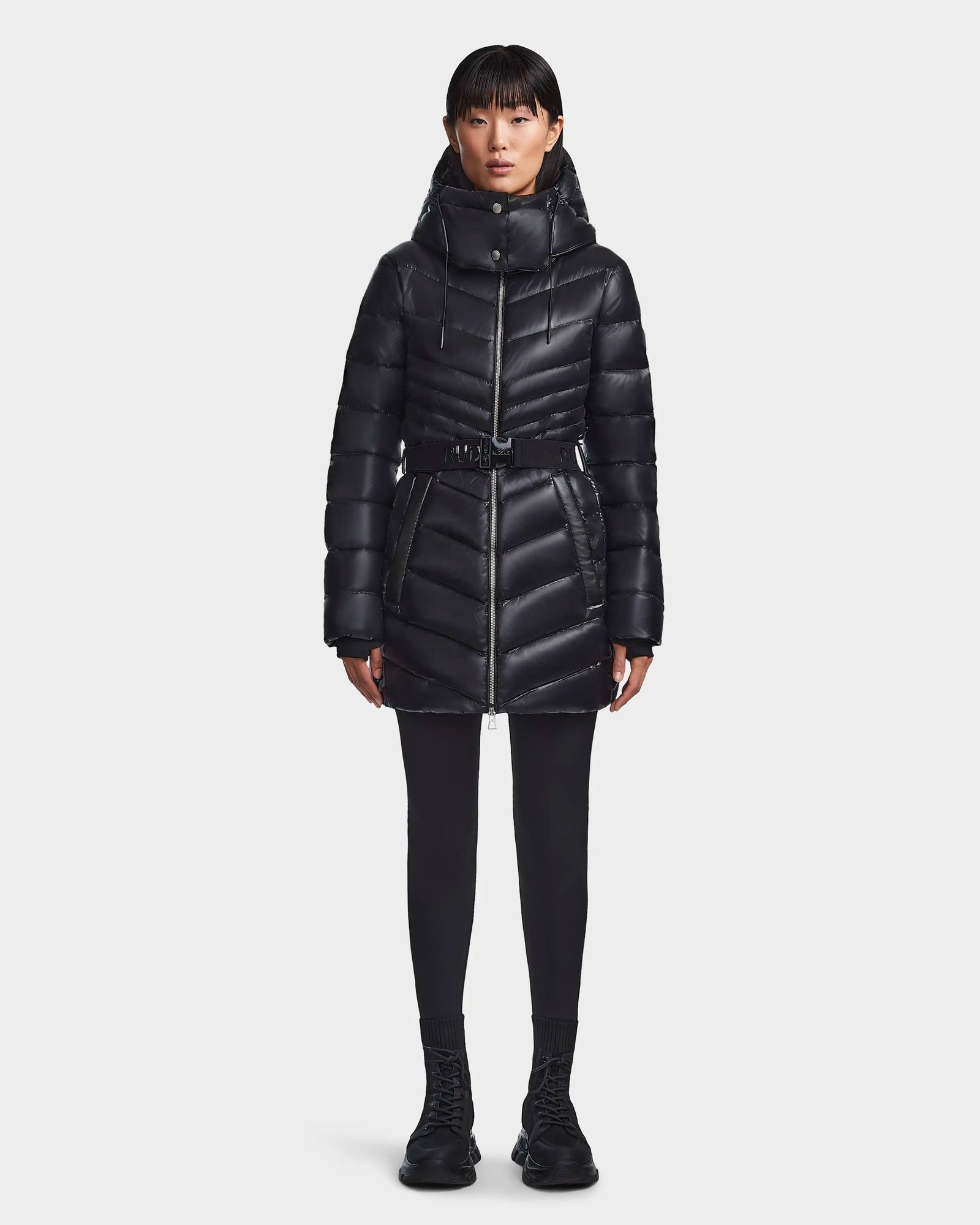 A woman in the Rudsak MALAYA - L123510 Black women’s down puffer jacket with herringbone quilting.
