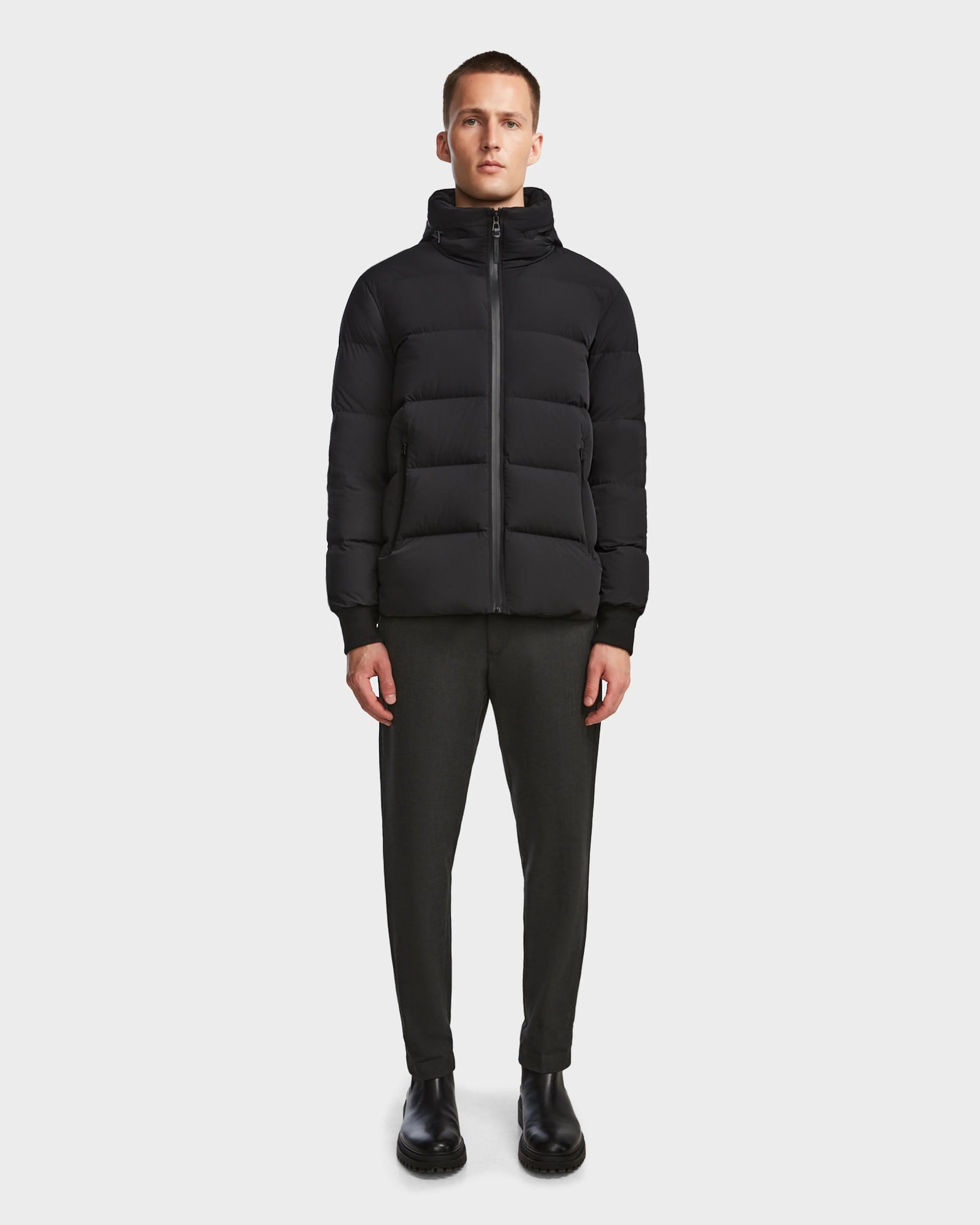 A man wearing the Rudsak DRAL - 6124503 Black mens wool jacket.