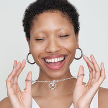Detail image of a woman standing wearing the Claressa Earrrings Medium in Silver