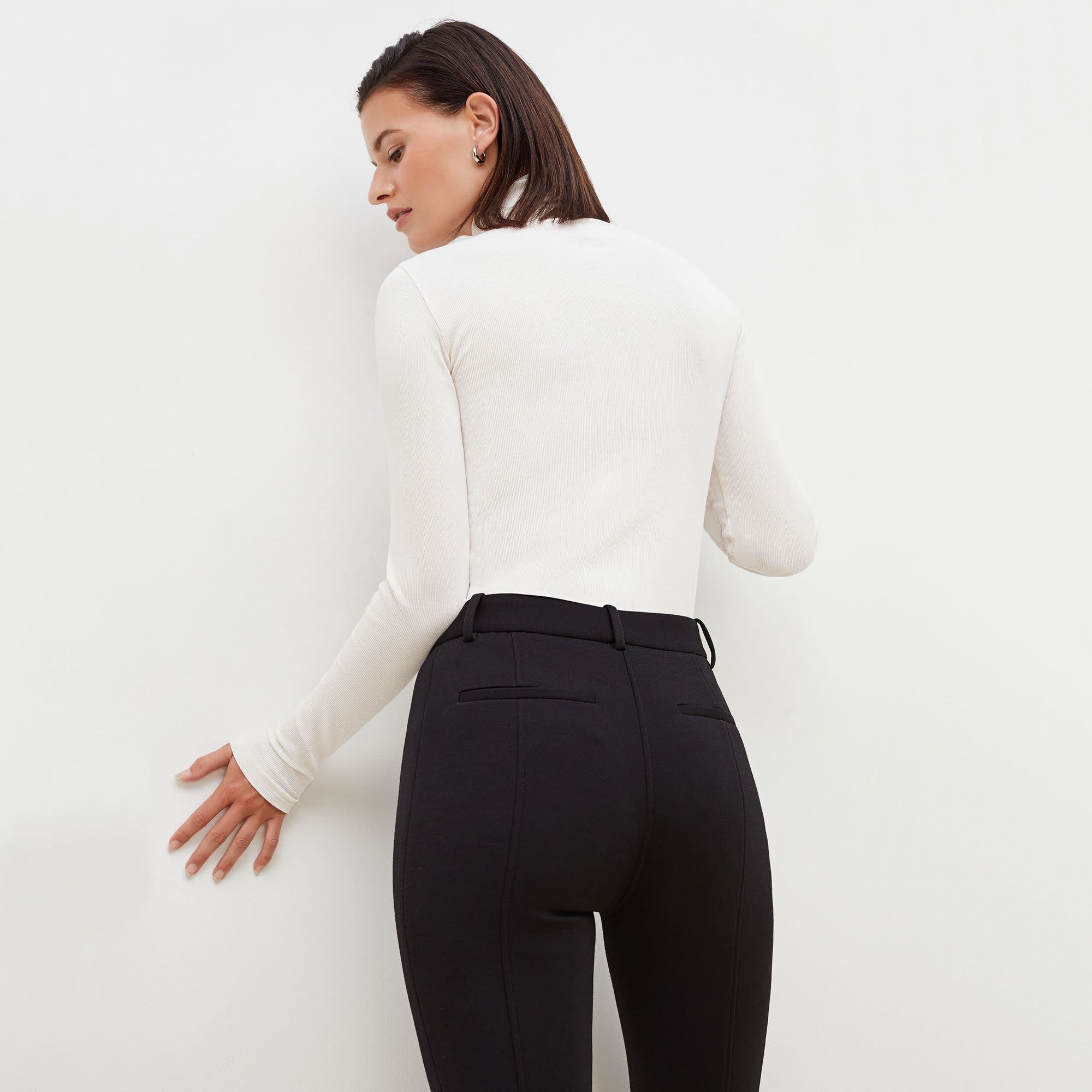 Back image of a woman standing wearing the Curie Pant--Worth in Black