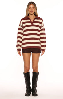 Front view of a burgundy and cream striped knit polo sweater with a relaxed fit and long sleeves