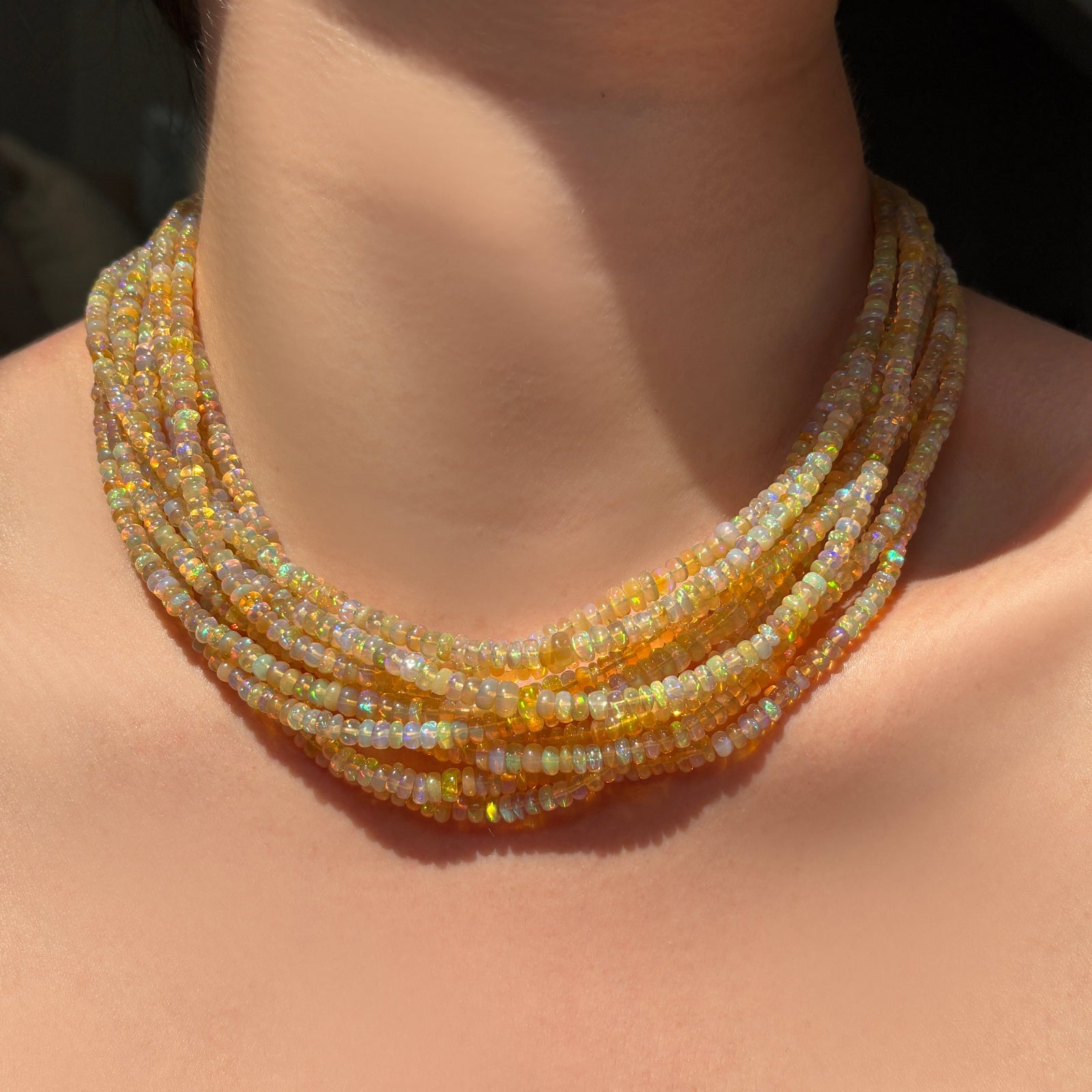Eclipse opal necklaces layered on the neck.
