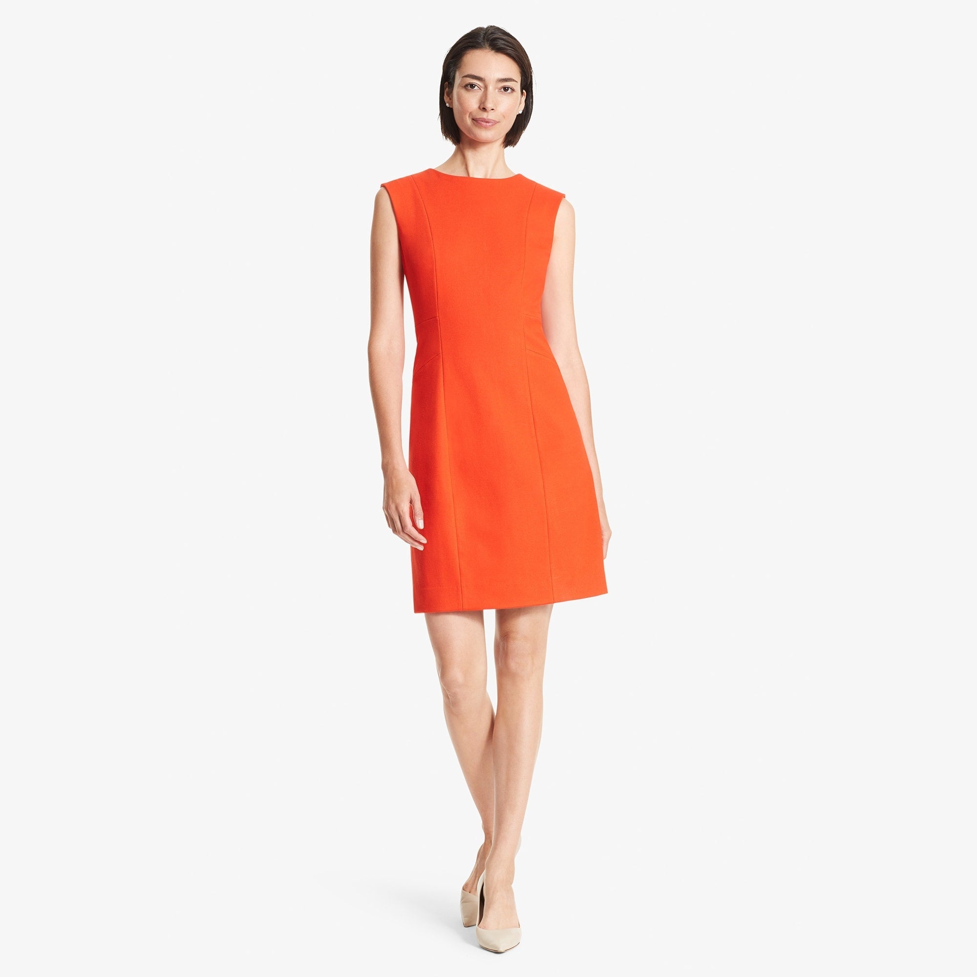 Front image of a woman standing wearing the Giovanna dress in Tangerine | Exclude