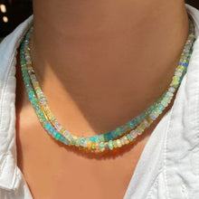 Shimmering beaded necklace made of faceted opals in shades of Blue, Teal, green and pale blue on a gold linking ovals clasp Styled on a neck layered with the Natural-Multi Faceted Opal Necklace