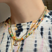 mermaid disco opal necklace with bead chain and marquise molten solitaire charm over a tie dye tee.