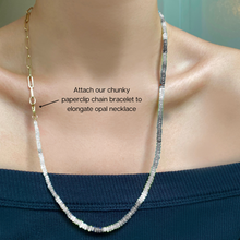  Shimmering beaded necklace made of smooth opal rondels in shades of black, navy, and green on a slim gold lobster clasp.