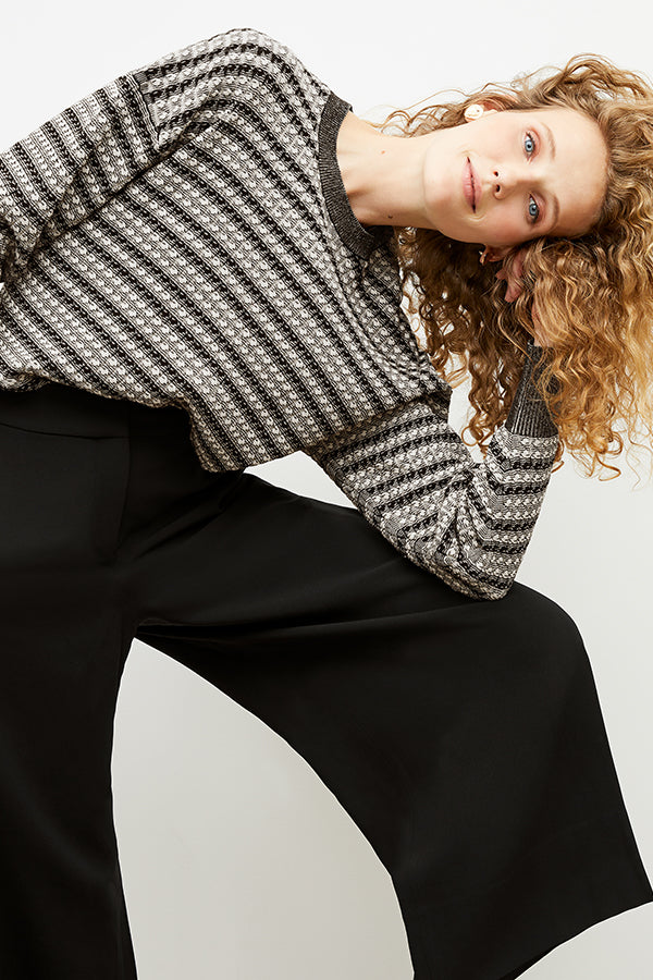 Front image of a woman wearing the tyler sweatshirt in black and white | Exclude
