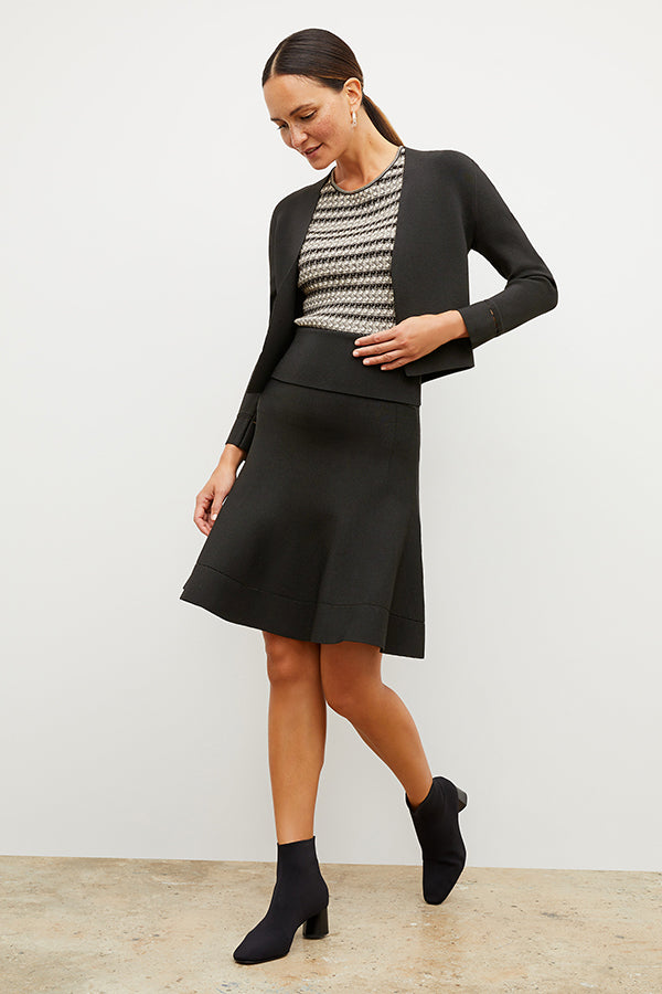 Front image of a woman standing wearing the Sant Ambroeus jardigan in black | Exclude